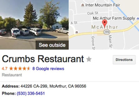Crumbs Restaurant parking lot with vehicles and exterior view, located in McArthur, California
