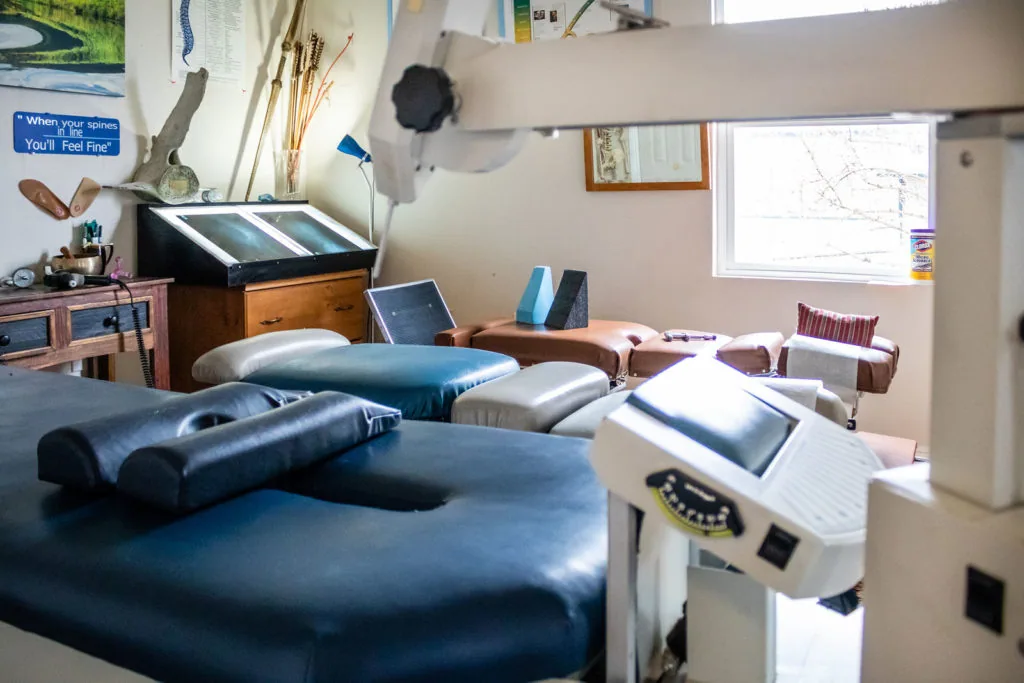 Chiropractic treatment room with adjustment table, exercise equipment, and therapeutic devices
